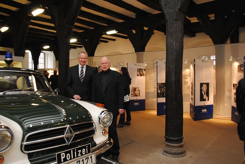 Bremens Innensenator Ulrich Mäurer und Polizeipräsident Lutz Müller freuen sich über den historischen Bremer Borgward-Streifenwagen in der Unteren Rathaushalle