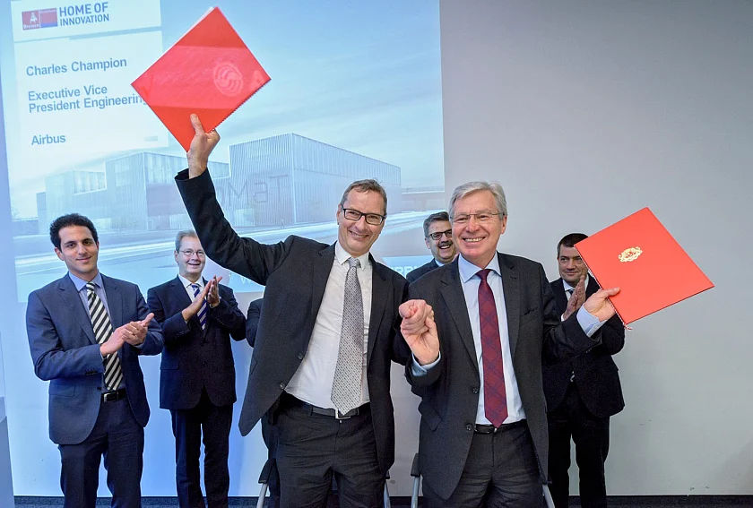 Charles Champion, Executive Vice President Engineering von Airbus, und Bürgermeister Jens Böhrnsen, Präsident des Senats der Freien Hansestadt Bremen, freuen sich über die Unterzeichnung durch die Airbus Group und das Land Bremen. Im Hintergrund freuen sich mit (v.l.n.r.): Prof. Dr. Kurosch Rezwan, Konrektor für Forschung der Universität Bremen, Volker Thum, Standortleiter von Airbus, Andreas Heyer, Vorsitzender der Geschäftsführung der WFB Wirtschaftsförderung Bremen GmbH, und Dr. André Walter, Vice President Materials & Processes von Airbus