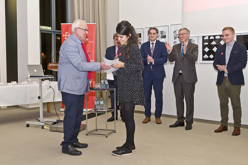 Klaus Platz, Ehrenmitglied der Bremischen Hafenvertretung, überreicht das Ernennungszertifikat an eine neue Logistikbotschafterin