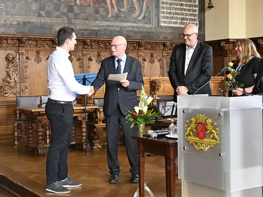 Innensenator Mäurer überreicht einem neu eingebürgerten Bremer seine Urkunde. Foto: Senatspressestelle