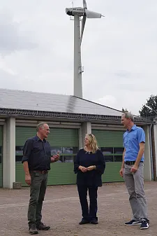 Grüner Strom dank Solar- und Windkraftanlage – Wilfried Döscher, Geschäftsführer vom Deichverband am rechten Weserufer (l.), erzählt Senatorin Schaefer und energiekonsens-Geschäftsführer Martin Grocholl (r.) von den Klimaschutzmaßnahmen des Deichverbands. Foto: energiekonsens