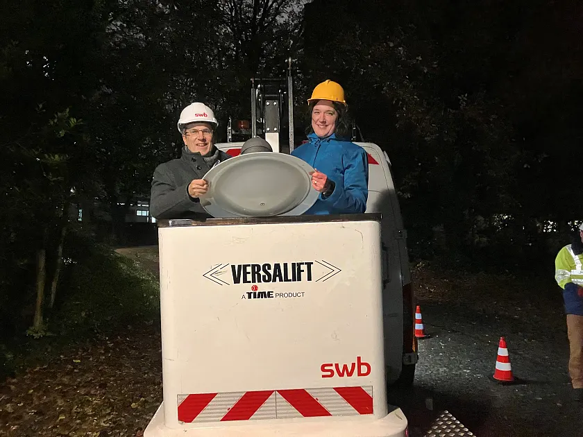 swb-Vorstandssprecher Dr.  Karsten Schneiker und die Senatorin für Umwelt, Klima und Wissenschaft halten die finale Leuchte des LED-Projekts in den Händen. Jetzt leuchtet sie nachhaltig zwischen Staatsarchiv und ehemaligem Bundesbankgebäude. Foto: Umweltressort