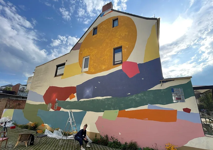 Elfin Açar vor dem neuen Wandbild Grüß Dich. 