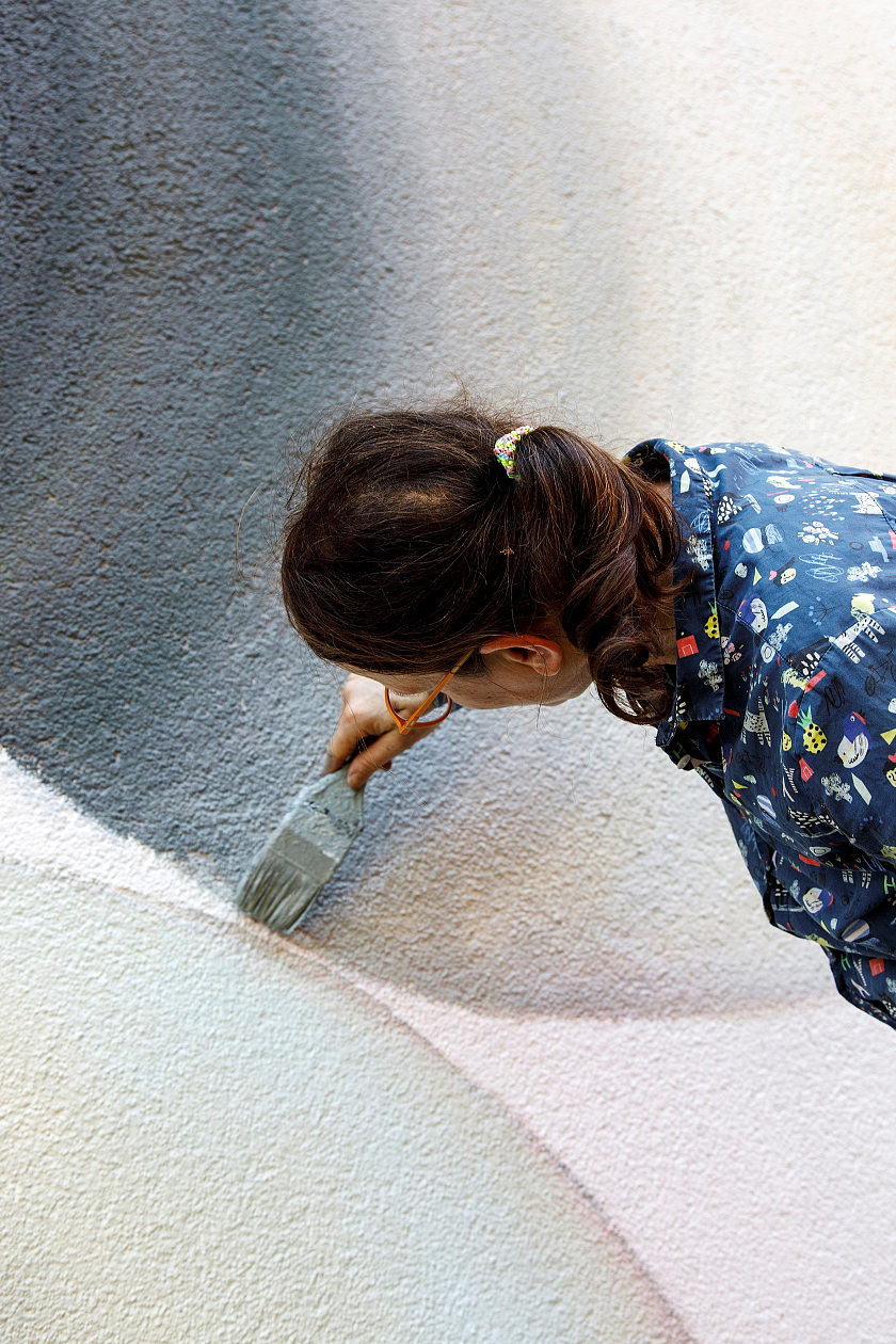 Marina Schulze bei der Arbeit an ihrem Fassadenkunstwerk look in am Zentrum für Kunst.